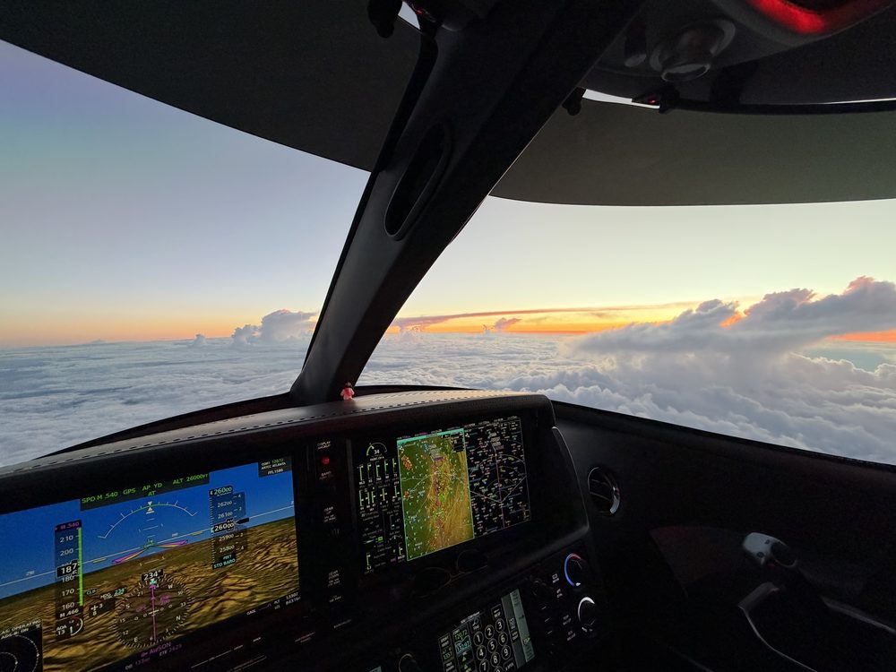 Cirrus SF50 Vision Jet cockpit at sunset above a cloud deck