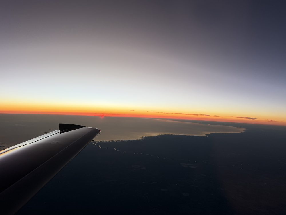 Vision Jet wing over the coastline at sunset